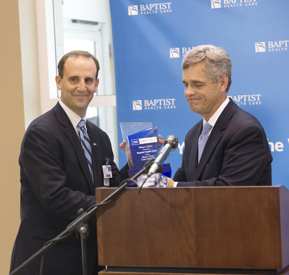 Mark Faulkner - CEO Baptist Health Care accepting Mayo Clinic Care Network plaque from Dr. Stephen Lange, Assistance Professor of Medicine at Mayo Medical School 