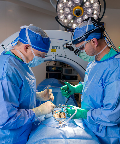 Two doctors performing spine surgery.